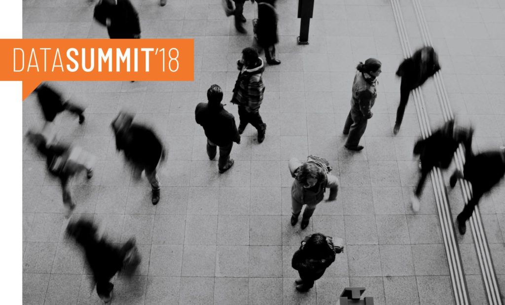 hero-datasummit18 People walking in the street with a logo design superimposed, brand created by Wonderlab