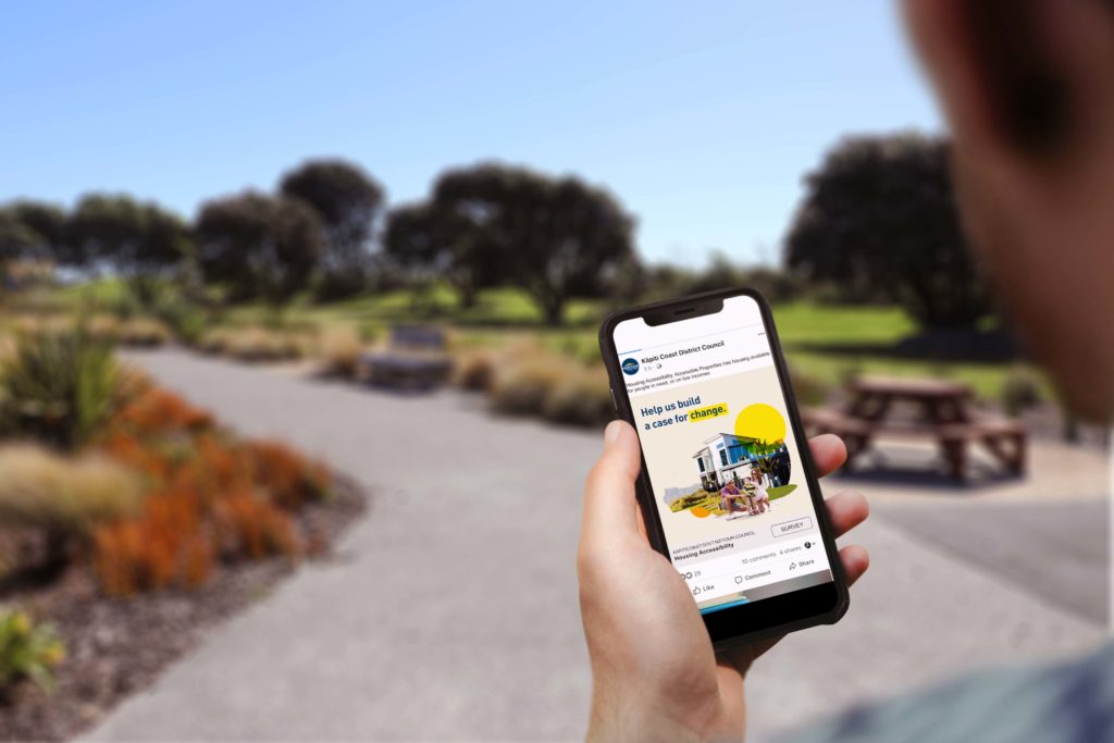 Kapiti Housing Survey Mobile phone with a social media post by communication strategists, Wonderlab