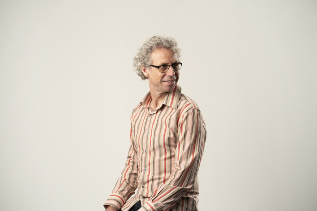 Marcus Baguley A man in a striped shirt is posing for a photo.
