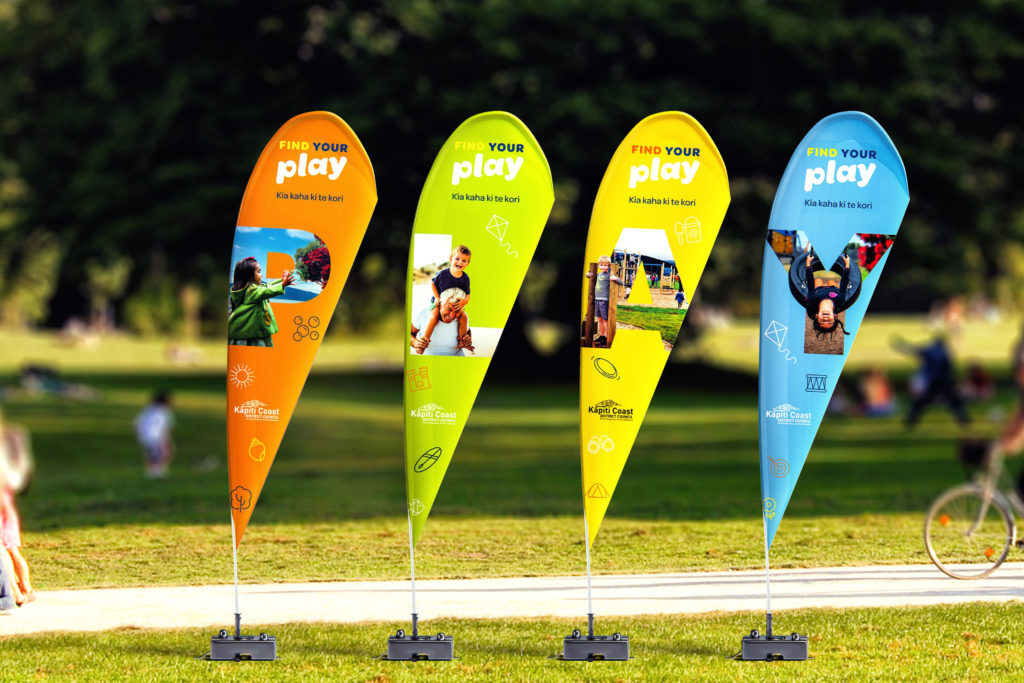 Find Your Play Wonderlab copy Four banner flags at a park, branded by Wellington design agency Wonderlab.