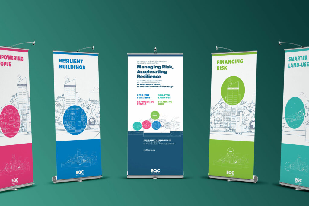eqc-conf-pullup-banners Four roll up banners on a green background.