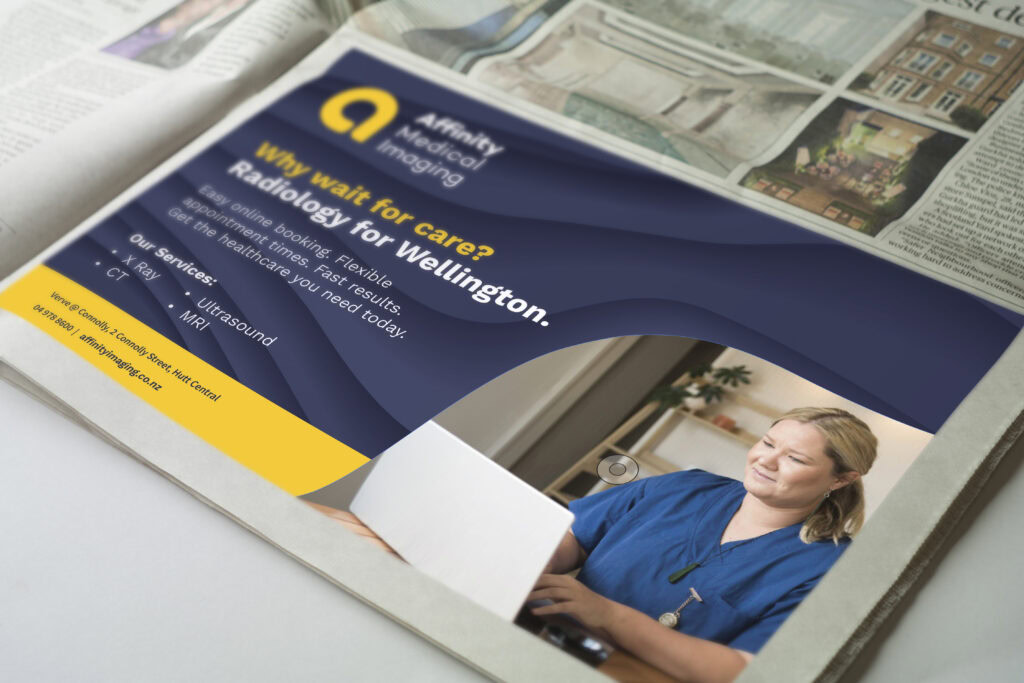 AFFINITY Pressad mockup copy The front page of a newspaper with a woman on a laptop.