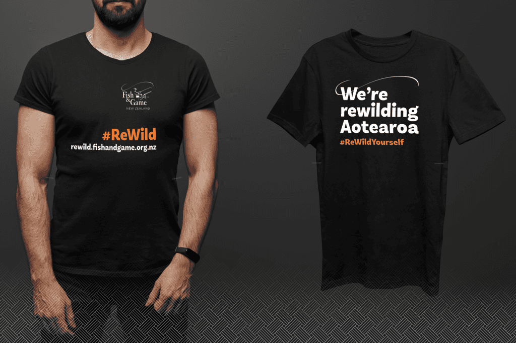 F&G tshirt design Two black t-shirts with #ReWild campaign slogans. The shirt on the left reads "Fish & Game New Zealand" with a website and #ReWild. The shirt on the right reads "We’re rewilding Aotearoa #ReWildYourself.