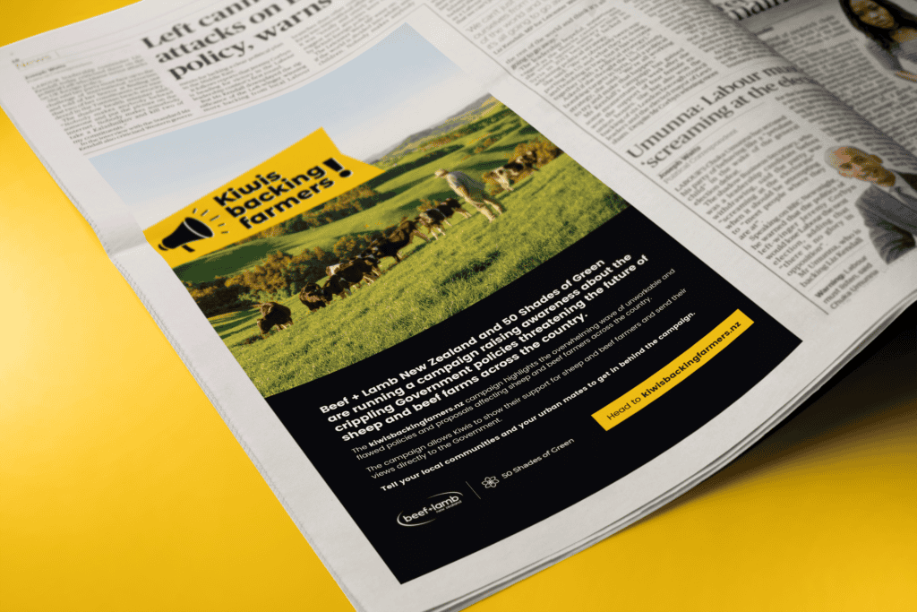 Beef&Lamb_Newspaper A newspaper page is open showing an article on the left and an advertisement on the right. The ad features a photo of cows grazing in a lush green field, with the bold text "Kiwis backing farmers!" and supportive statements below. The background color of the ad is predominantly black and yellow.