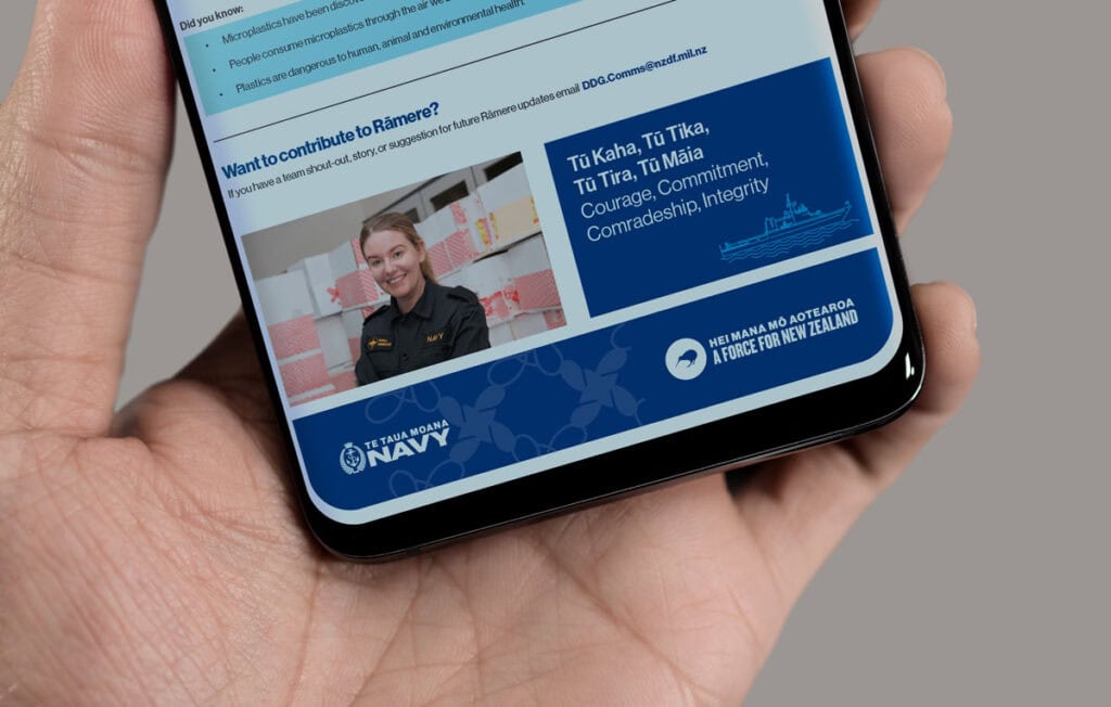 NZ-Navy-email-footer-mobile A person in a naval uniform smiling is displayed on a smartphone screen. The text below reads "Courage, Commitment, Comradeship, Integrity" next to logos for the New Zealand Navy.